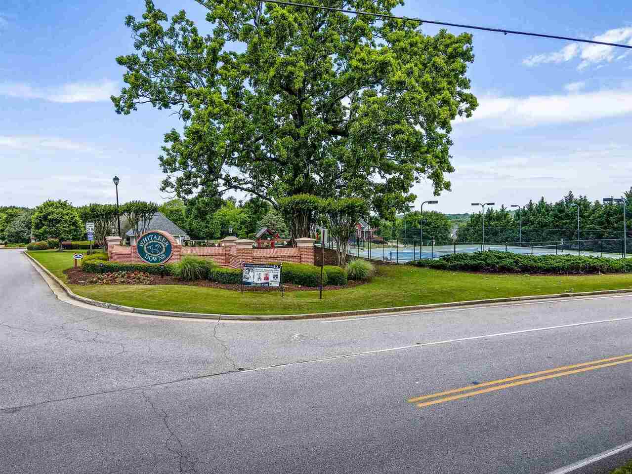 142 Reece Drive, Unit 4 Hoschton, GA 30548 - Photo 1 of 1 a view of a house with a big yard potted plants and large trees