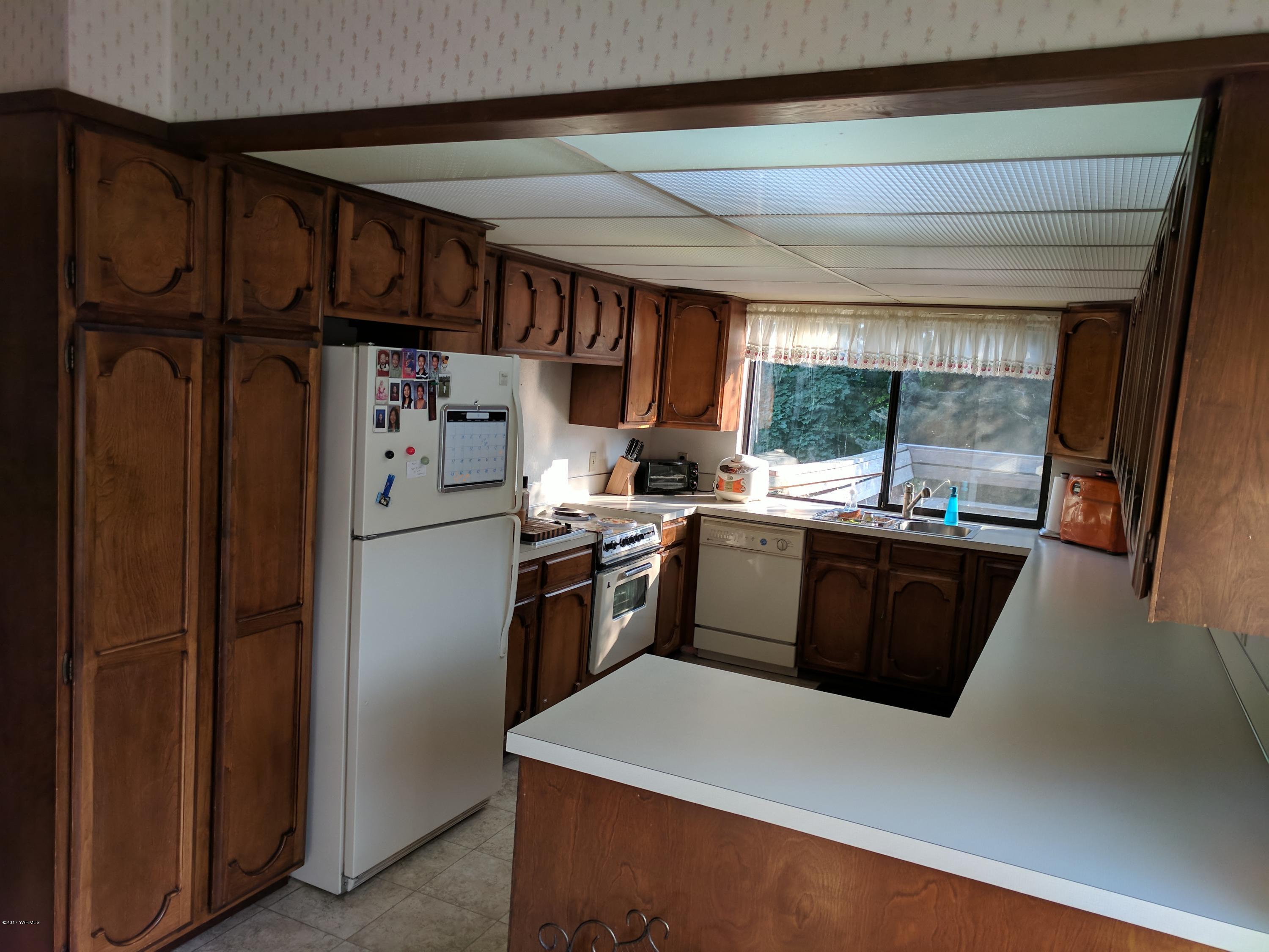 401 North Wickersham Road Yakima, WA 98908 - Photo 3 of 10 a kitchen with stainless steel appliances granite countertop a refrigerator a sink a stove and a refrigerator