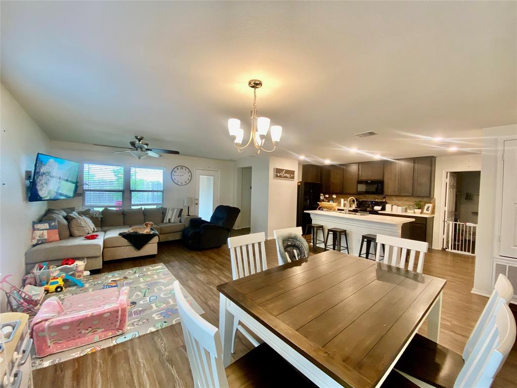 110 West Point Way Elgin, TX 78621 - Photo 4 of 19 An open concept living area connects the dining space seamlessly to the kitchen and main room.