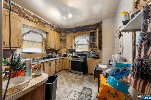 a kitchen with stainless steel appliances granite countertop sink stove and cabinets