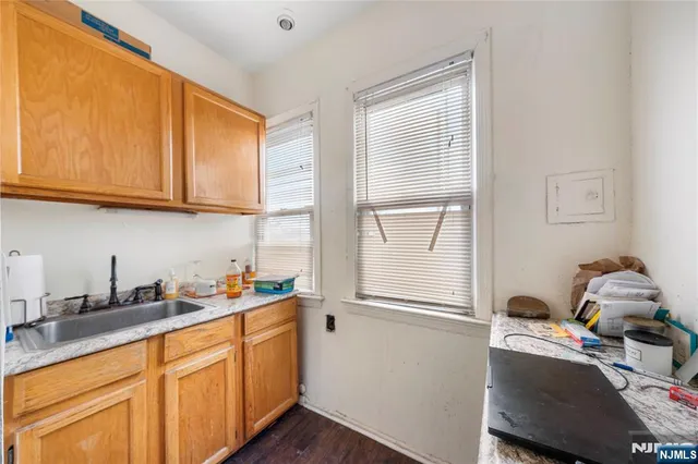 a kitchen with a sink cabinets and window