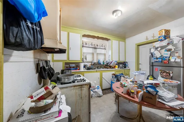 a kitchen with a table and chairs in it