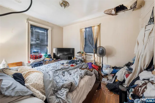 a bed room with a bed and a chair