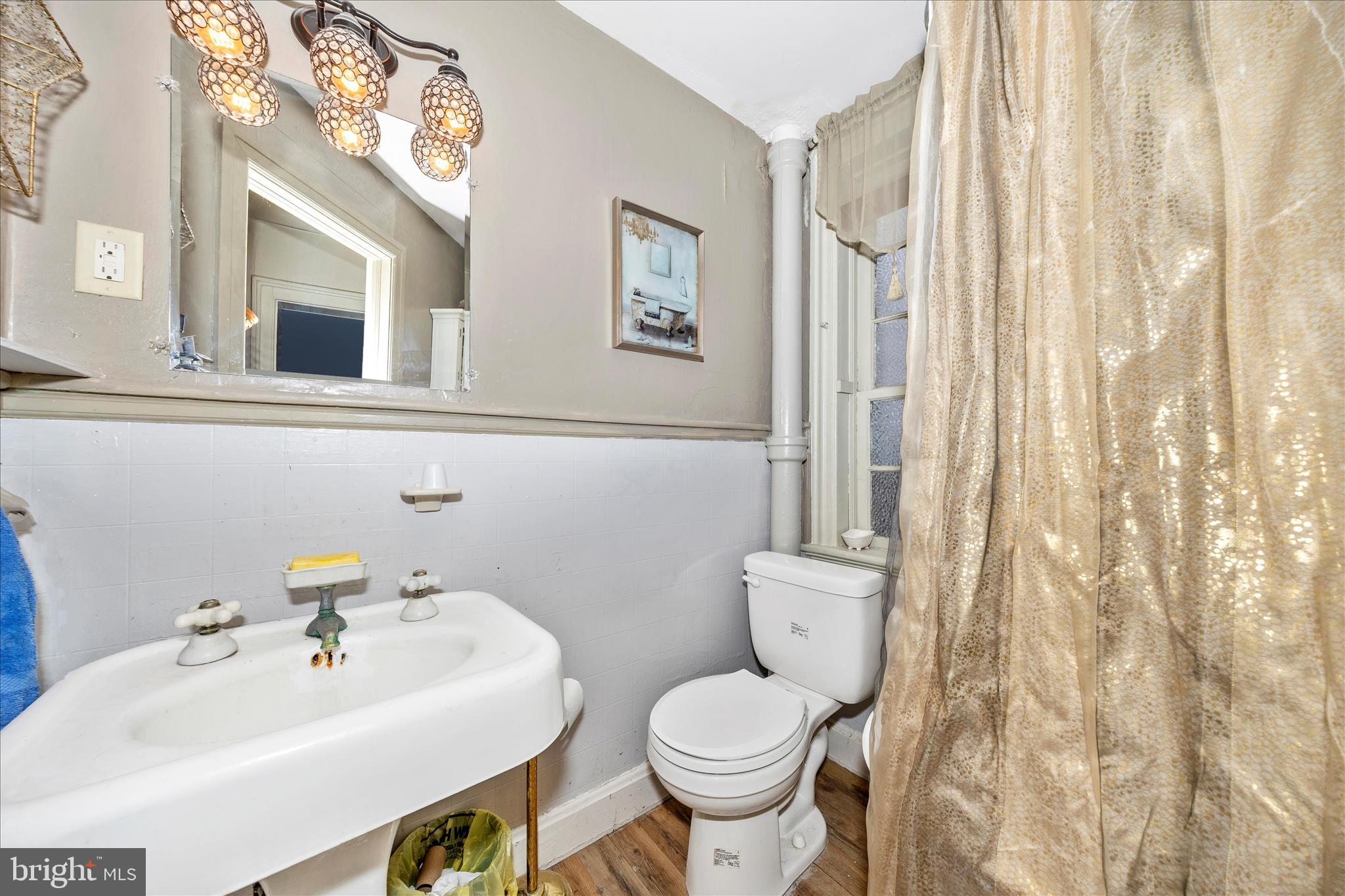 30 West Potomac Street Williamsport, MD 21795 - Photo 36 of 52 a bathroom with a sink mirror and toilet