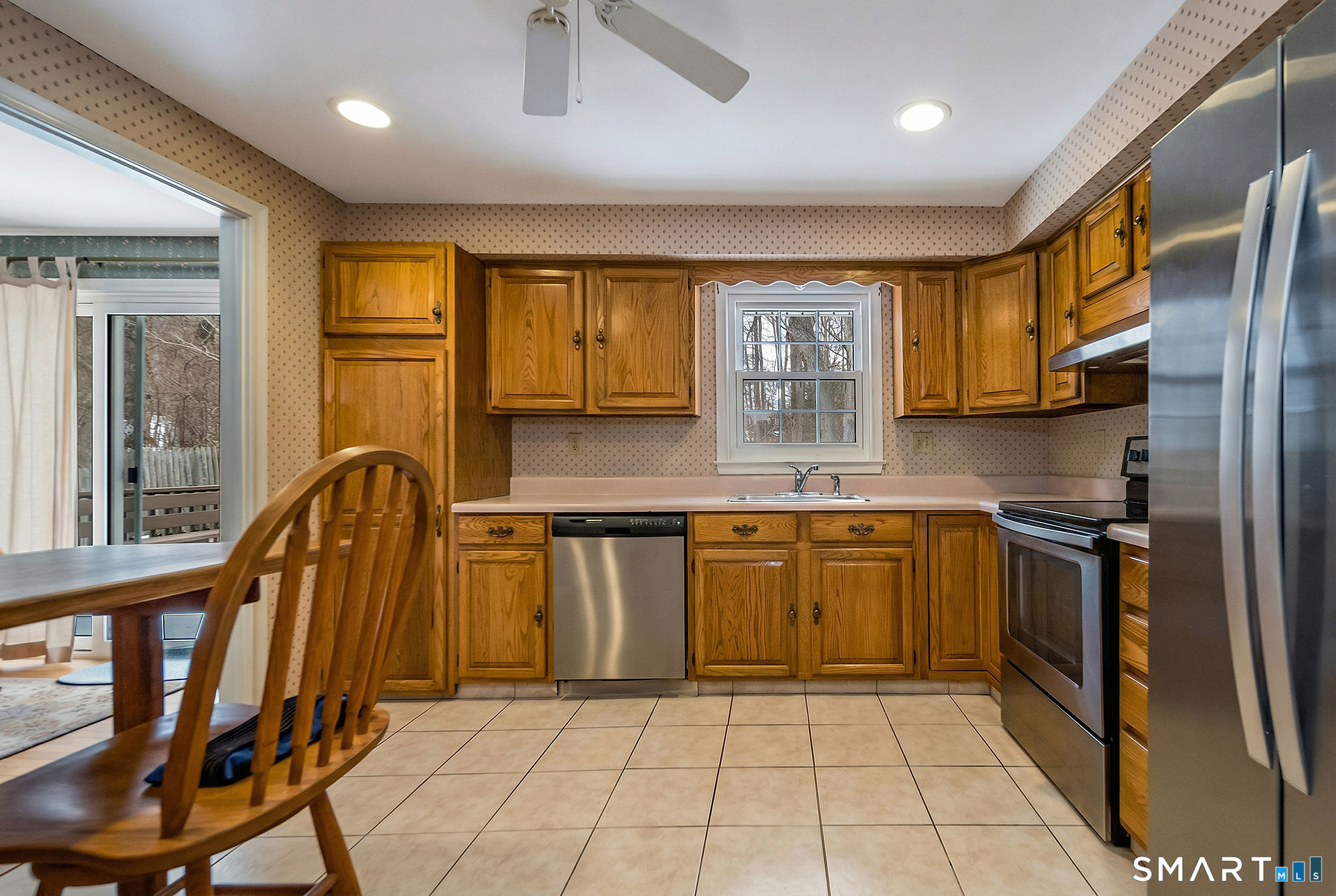 162 Yankee Peddler Path Madison, CT 06443 - Photo 11 of 39 a kitchen with stainless steel appliances granite countertop a refrigerator a stove top oven and a sink with granite countertops