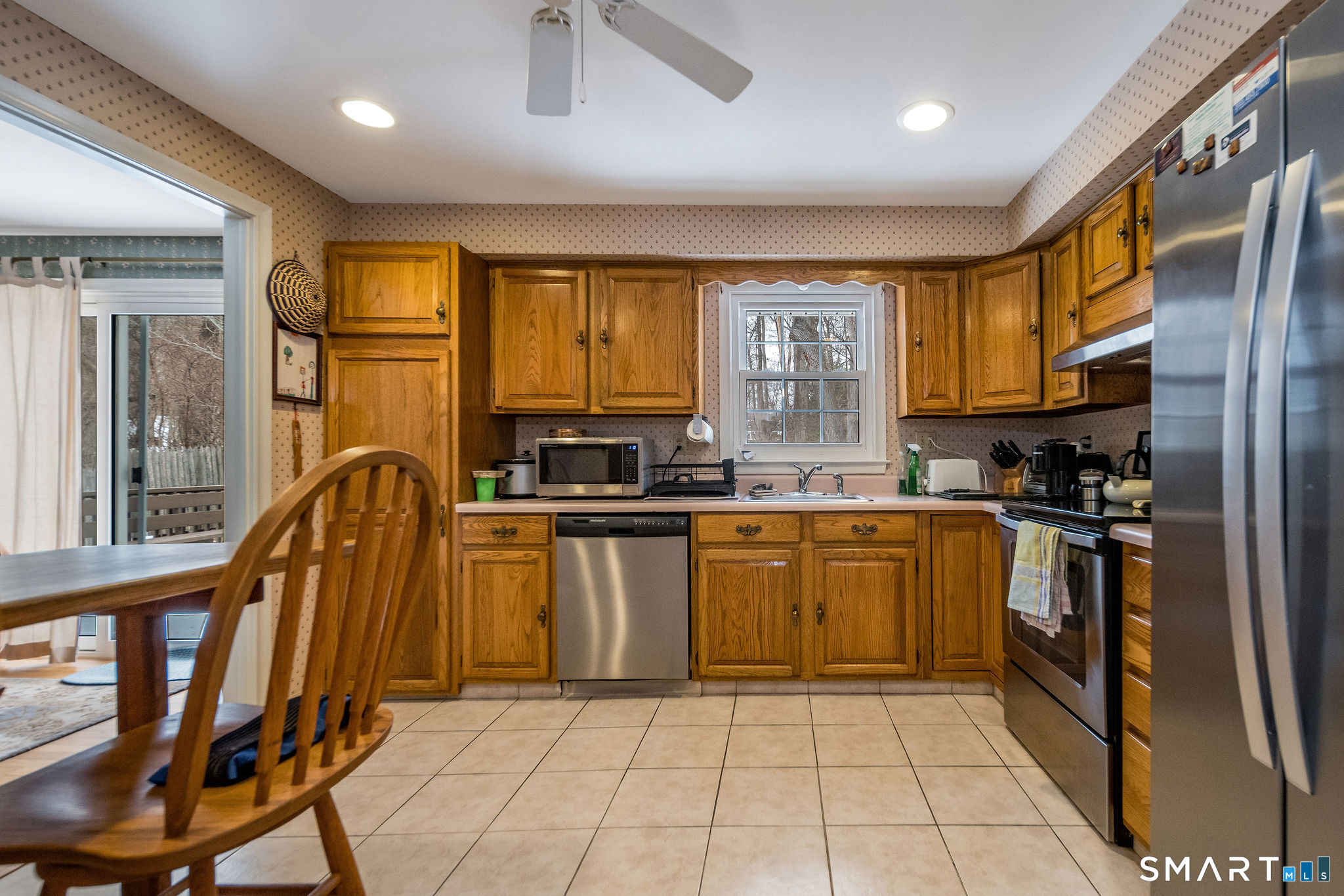 162 Yankee Peddler Path Madison, CT 06443 - Photo 12 of 39 a kitchen with a sink a counter top space cabinets and stainless steel appliances