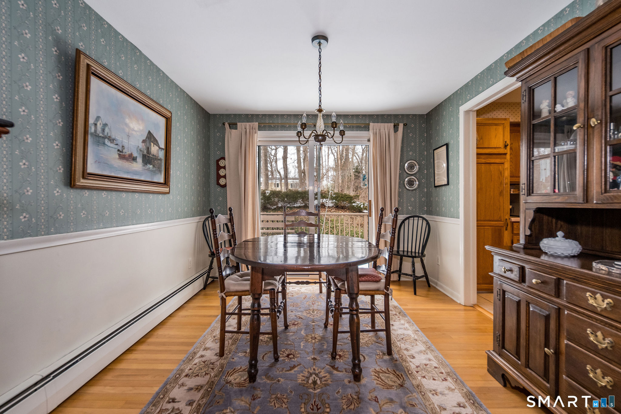 162 Yankee Peddler Path Madison, CT 06443 - Photo 13 of 39 a dining room with furniture a chandelier and wooden floor