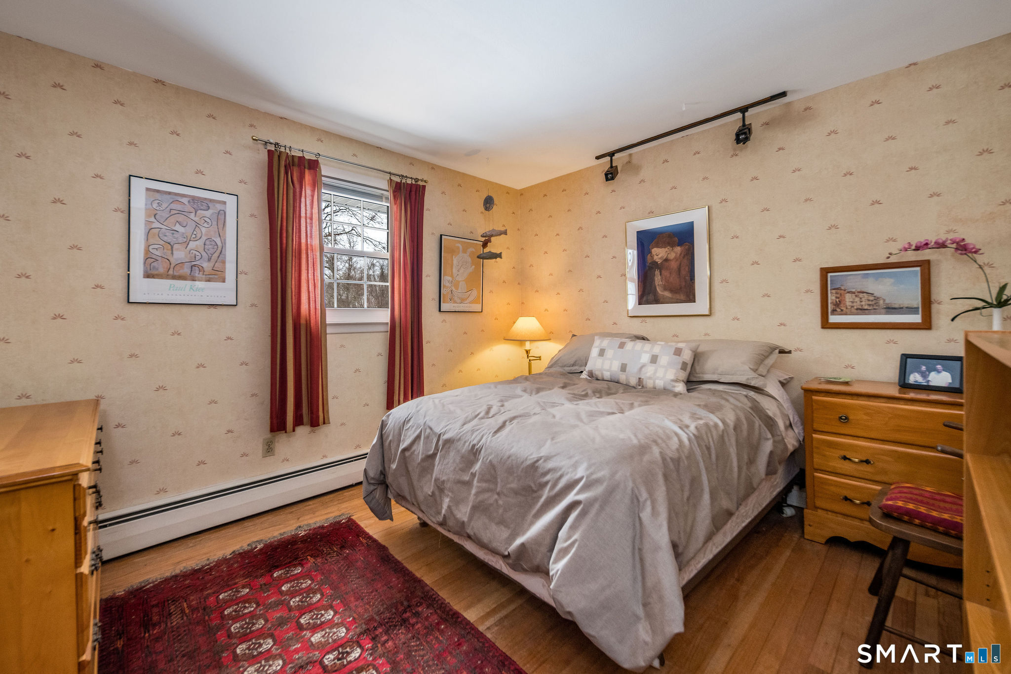 162 Yankee Peddler Path Madison, CT 06443 - Photo 19 of 39 a bedroom with a bed and wooden floor