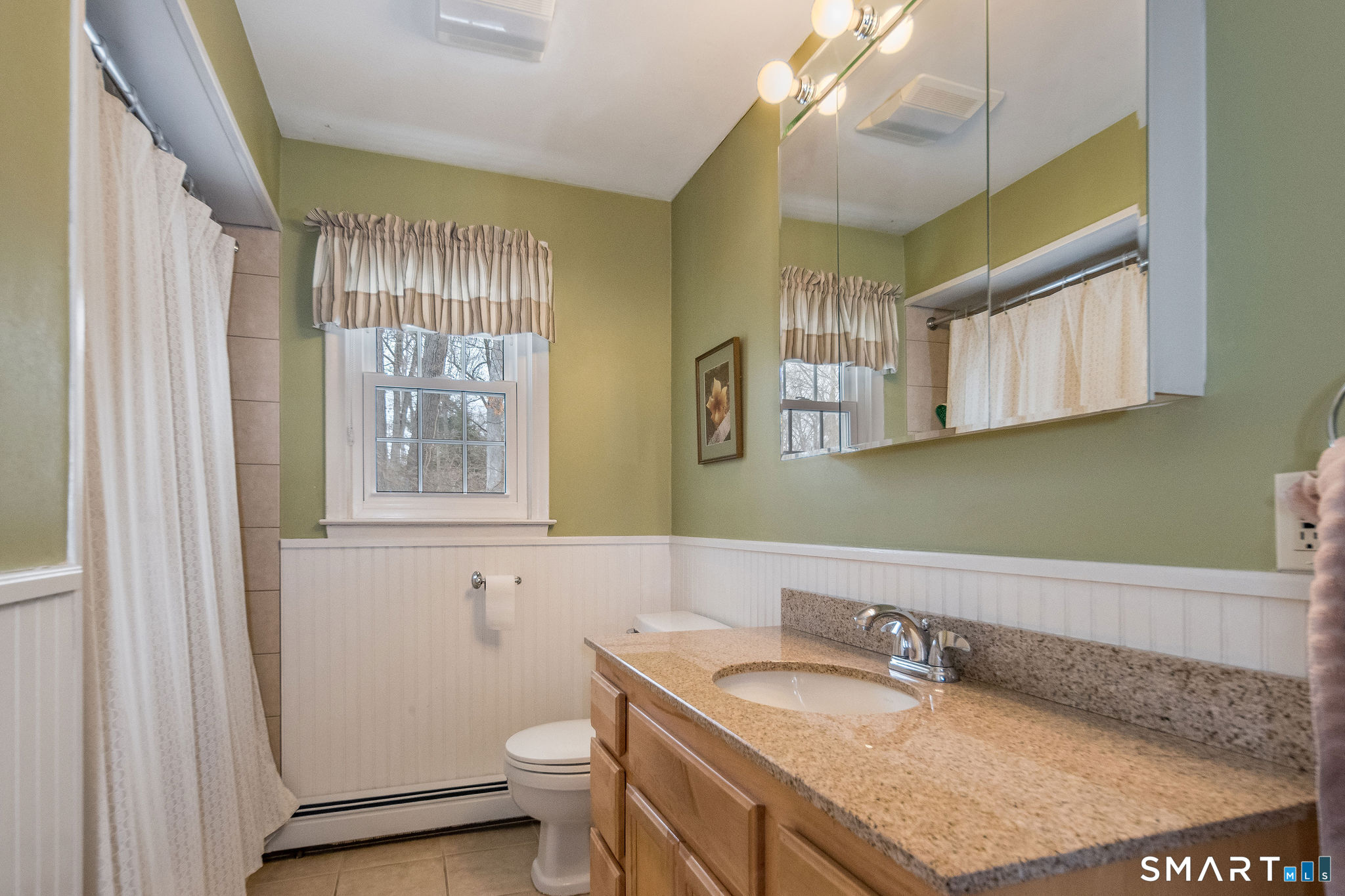162 Yankee Peddler Path Madison, CT 06443 - Photo 21 of 39 a bathroom with a granite countertop sink a toilet a mirror and a window