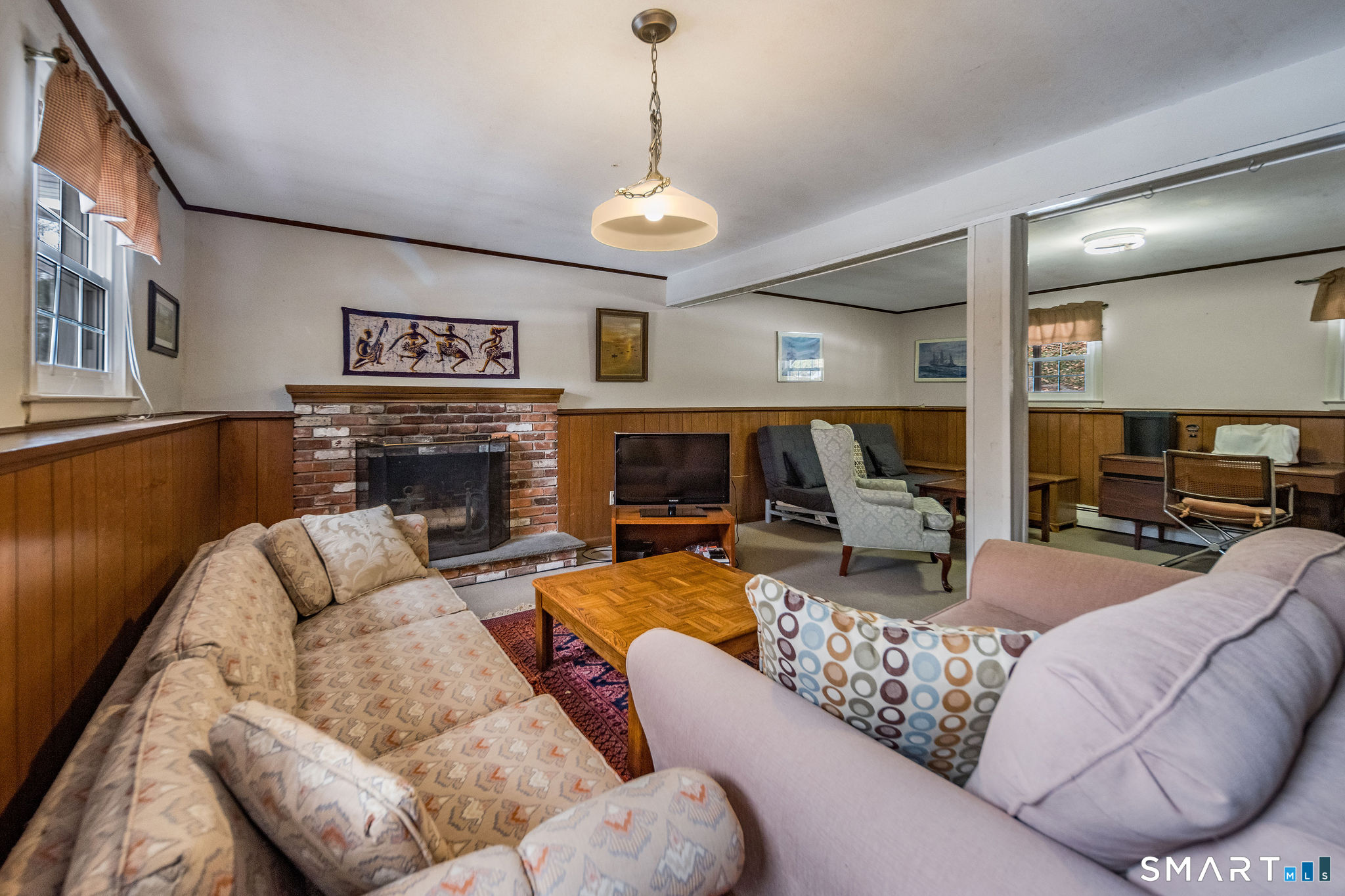162 Yankee Peddler Path Madison, CT 06443 - Photo 22 of 39 a living room with fireplace furniture and a chandelier
