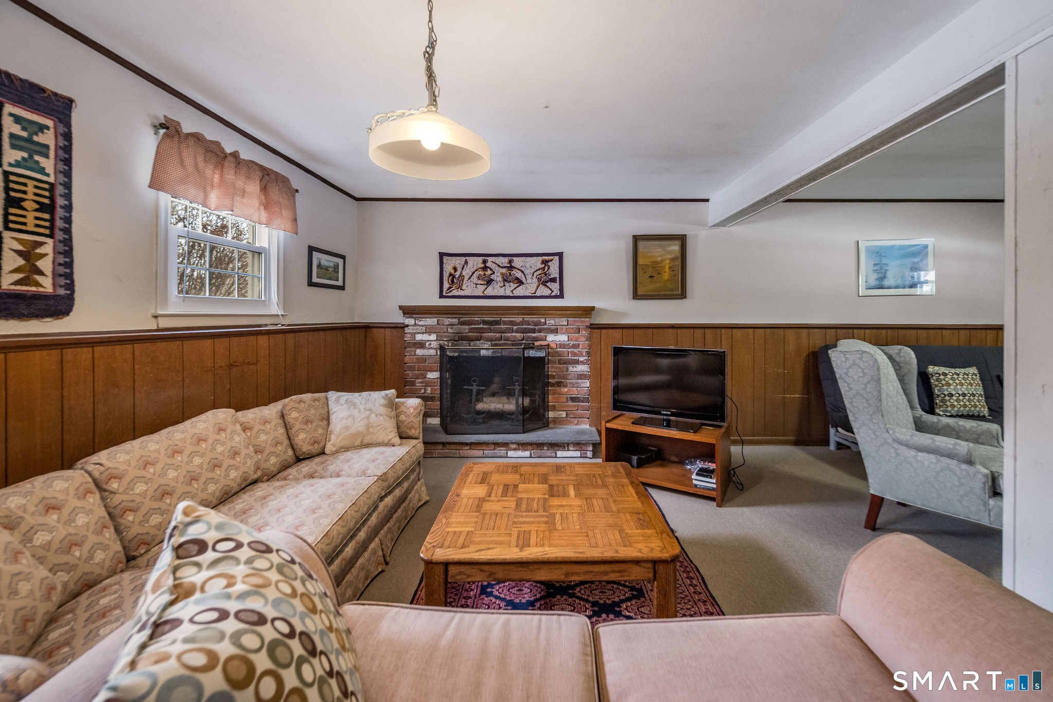 162 Yankee Peddler Path Madison, CT 06443 - Photo 23 of 39 a living room with furniture flat screen tv and a fireplace