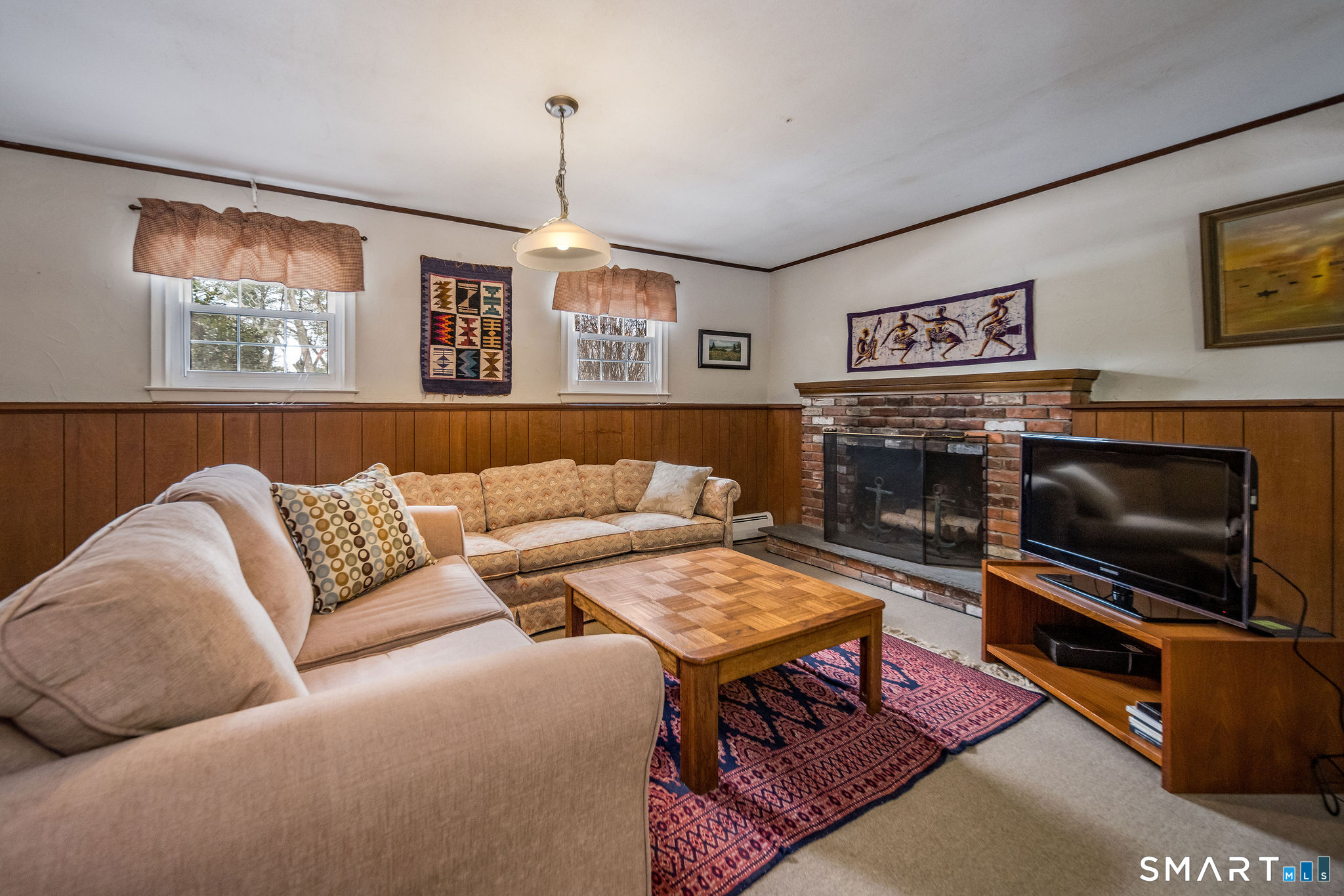 162 Yankee Peddler Path Madison, CT 06443 - Photo 24 of 39 a living room with furniture and a flat screen tv