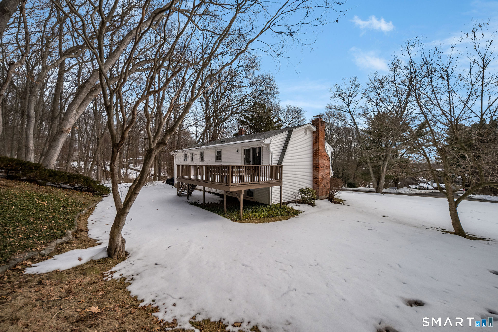 162 Yankee Peddler Path Madison, CT 06443 - Photo 28 of 39 a view of backyard with large trees and wooden fence