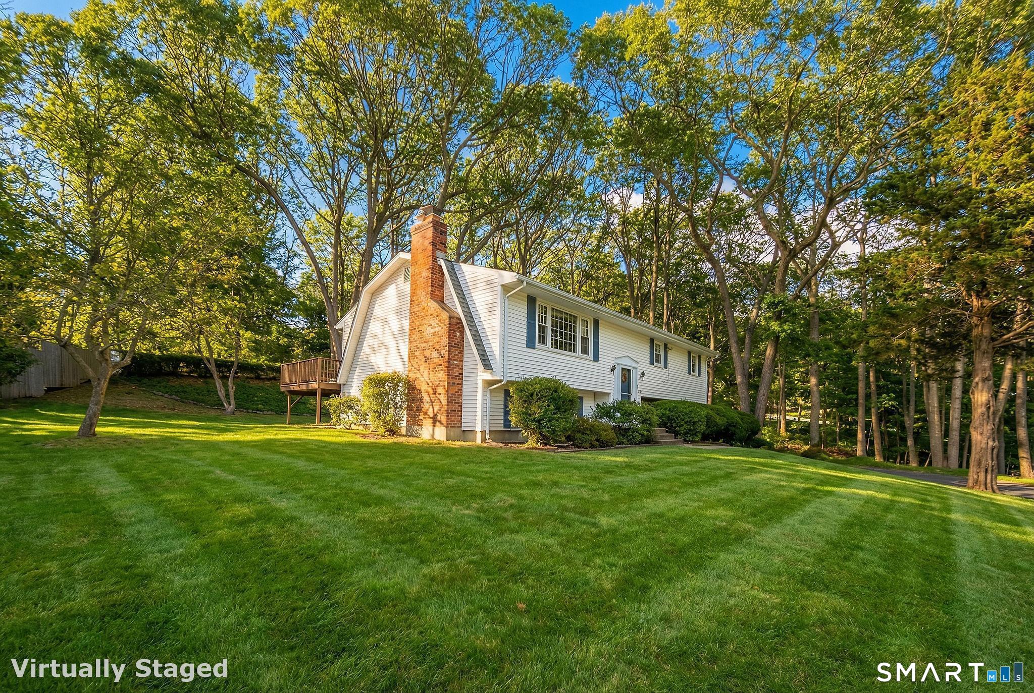 162 Yankee Peddler Path Madison, CT 06443 - Photo 31 of 39 a backyard of a house with table and chairs
