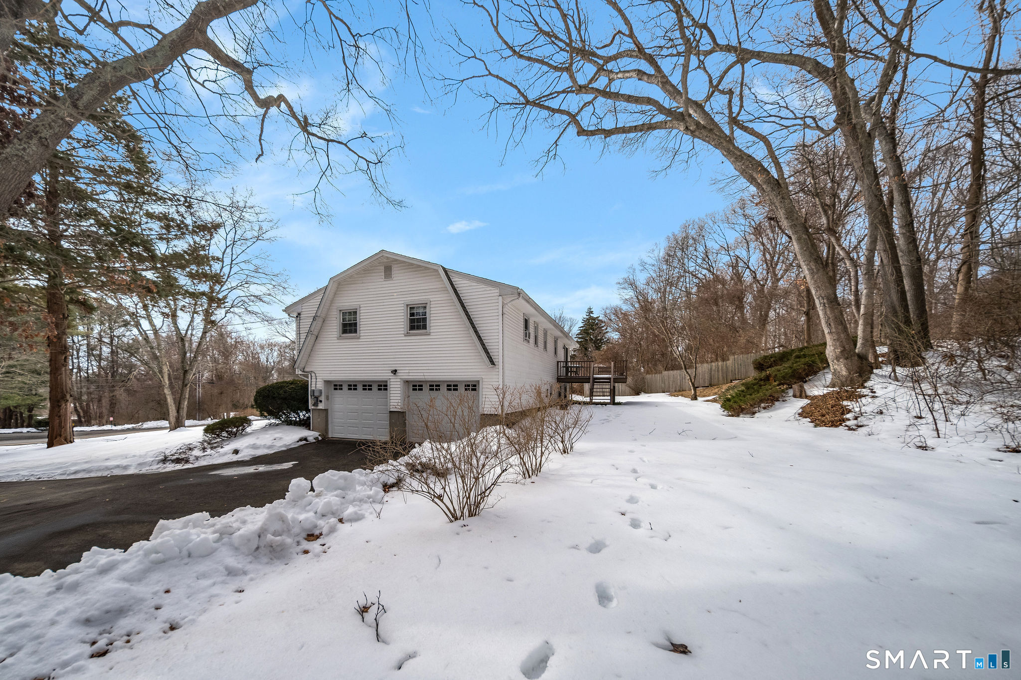 162 Yankee Peddler Path Madison, CT 06443 - Photo 36 of 39 a view of a white house with a yard covered in snow