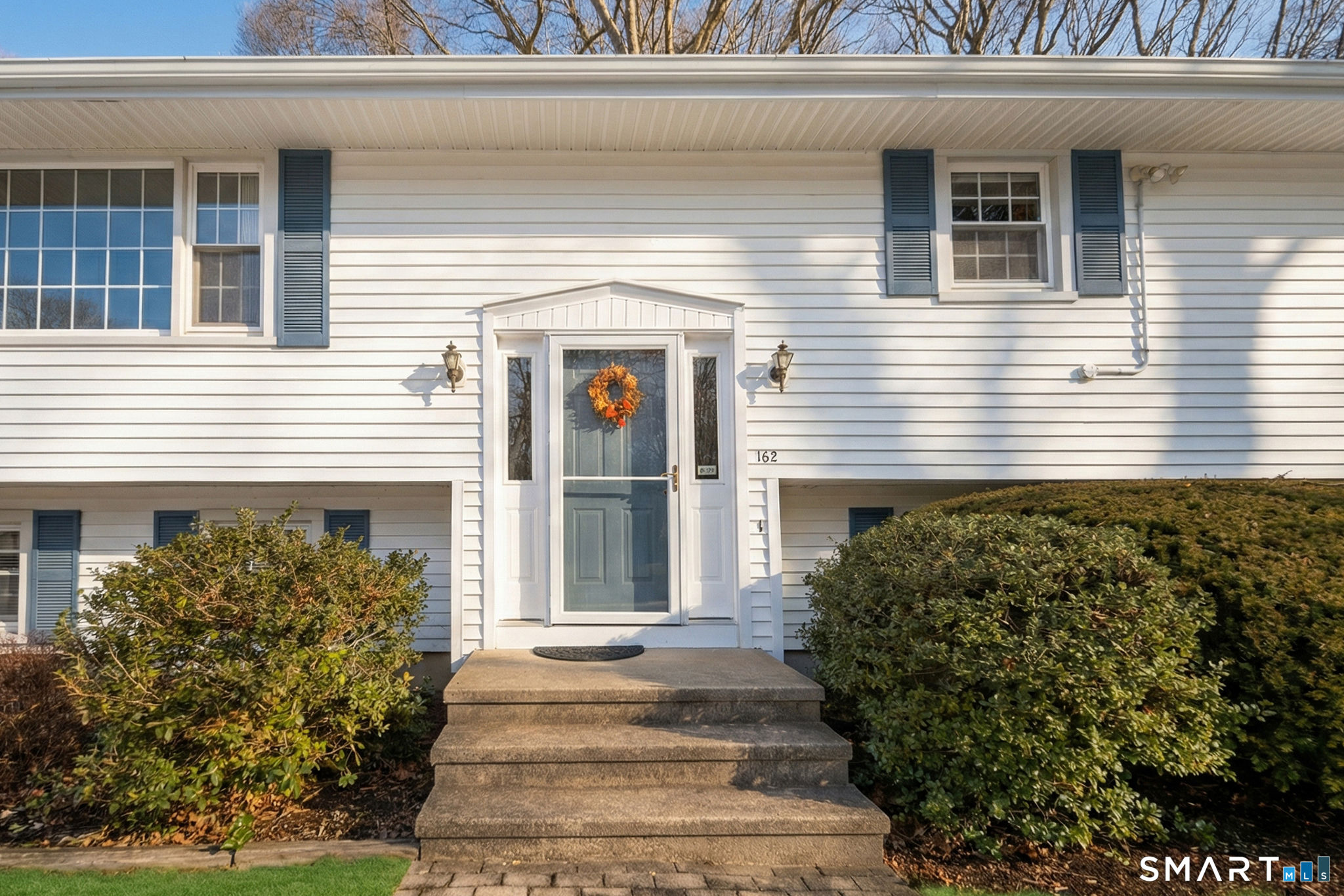 162 Yankee Peddler Path Madison, CT 06443 - Photo 4 of 39 a front view of a house with a garden