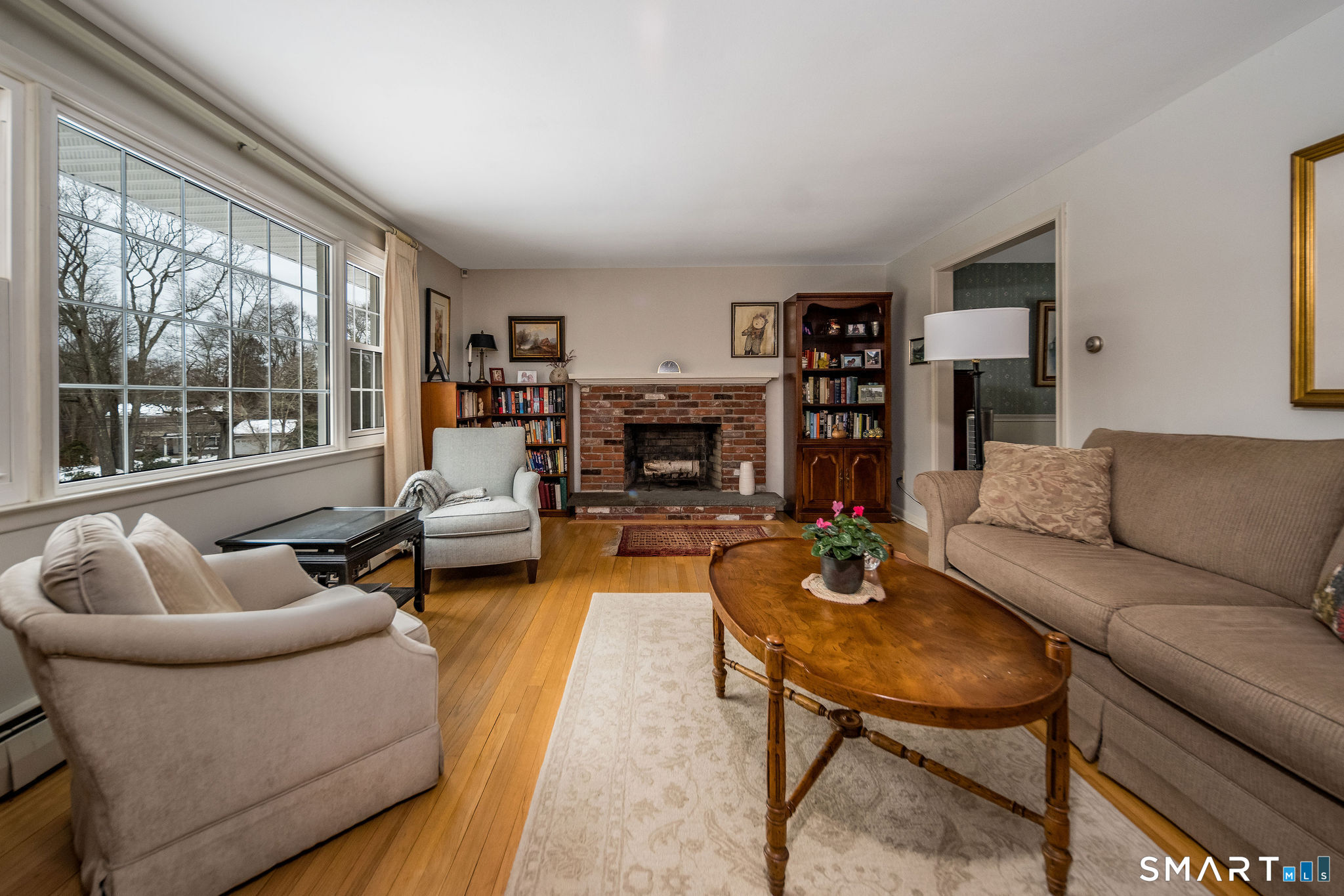 162 Yankee Peddler Path Madison, CT 06443 - Photo 6 of 39 a living room with furniture fireplace and a large window
