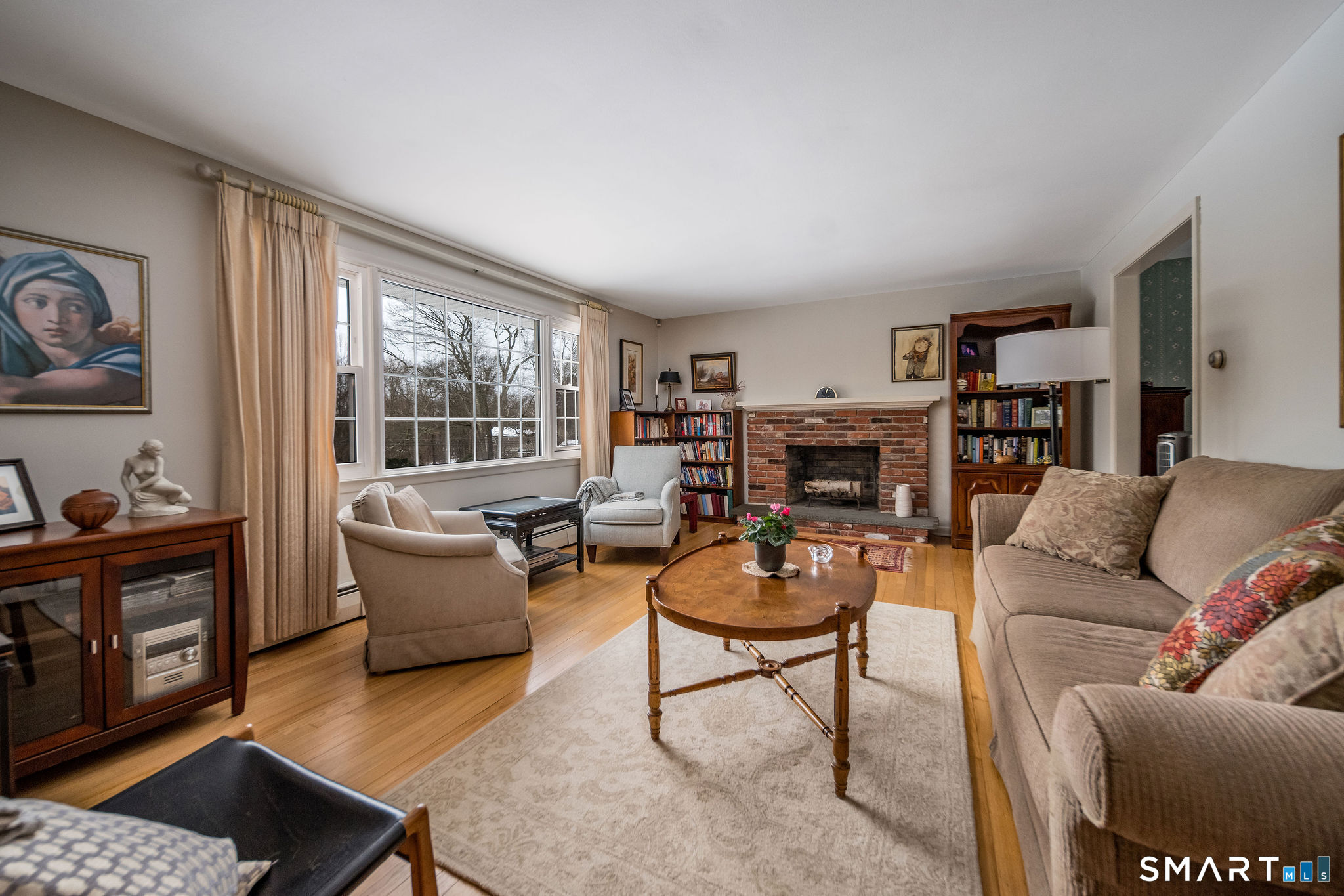 162 Yankee Peddler Path Madison, CT 06443 - Photo 7 of 39 a living room with furniture and a fireplace