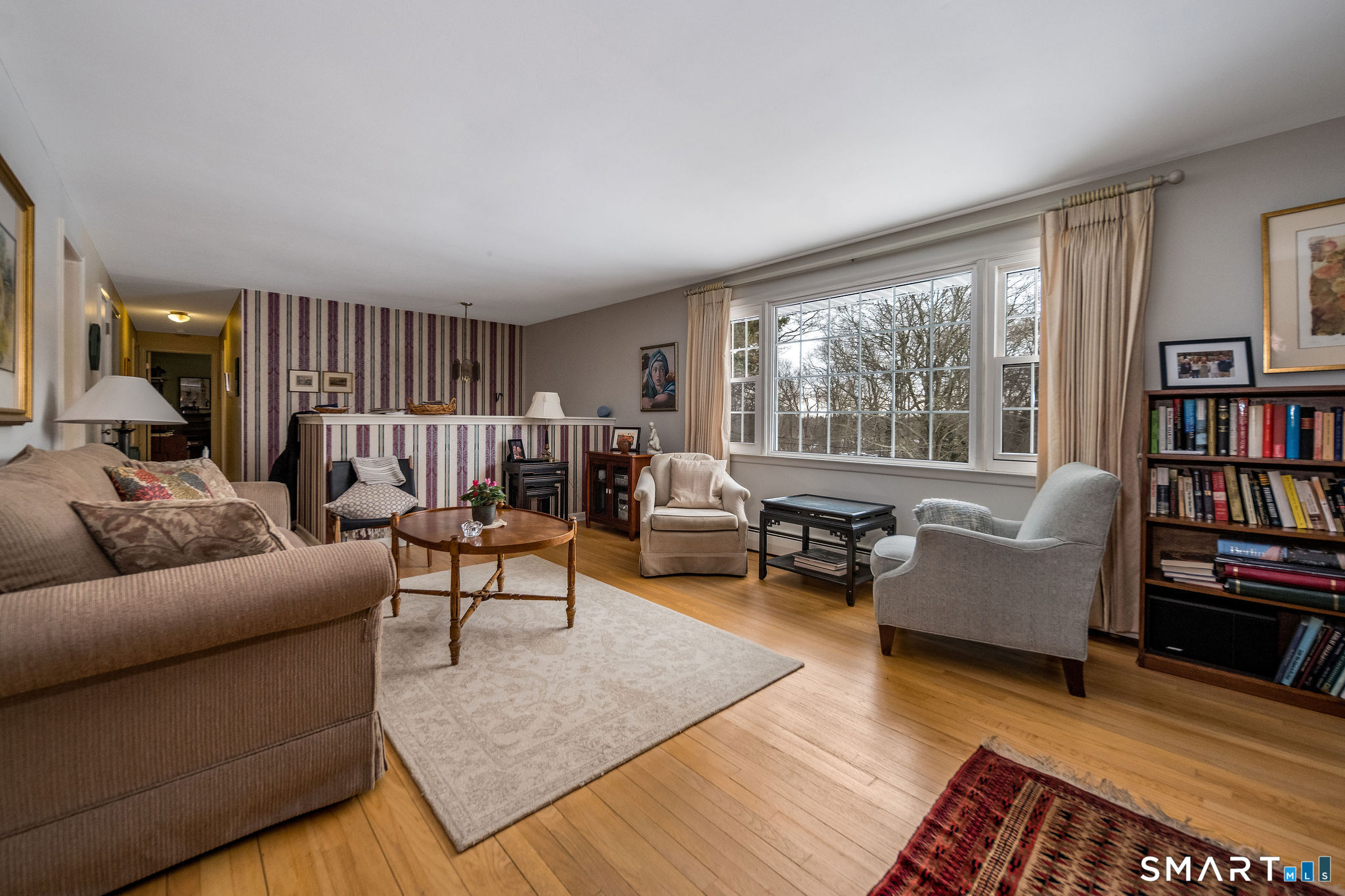 162 Yankee Peddler Path Madison, CT 06443 - Photo 8 of 39 a living room with furniture and a book shelf