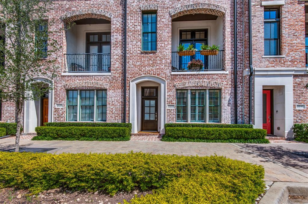 front view of a brick house with a yard