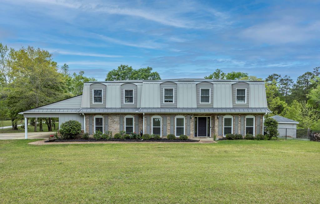 a front view of a house with a garden