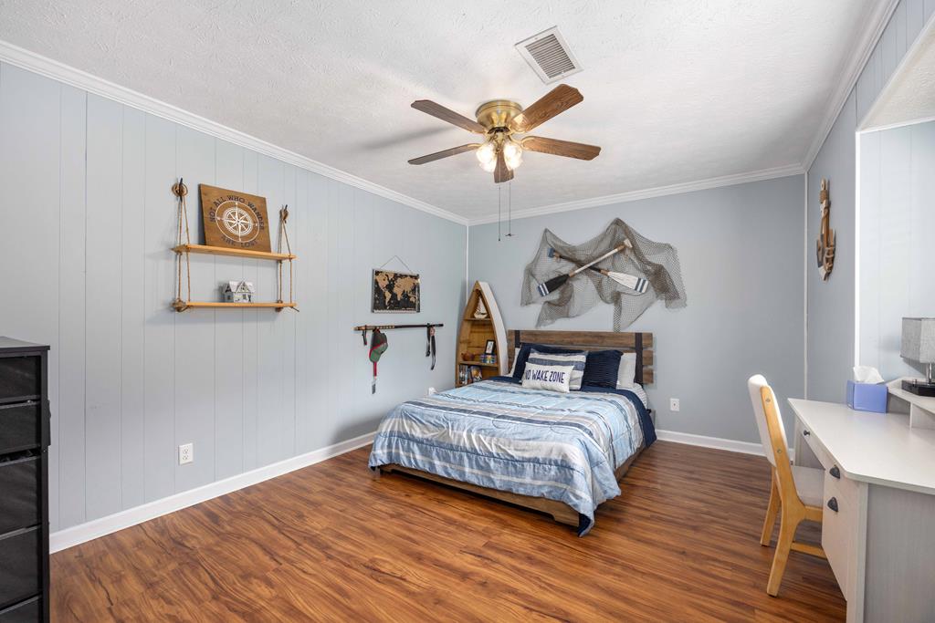 520 Terry Lane Fortson, GA 31808 - Photo 24 of 52 a bedroom with a bed and a chandelier