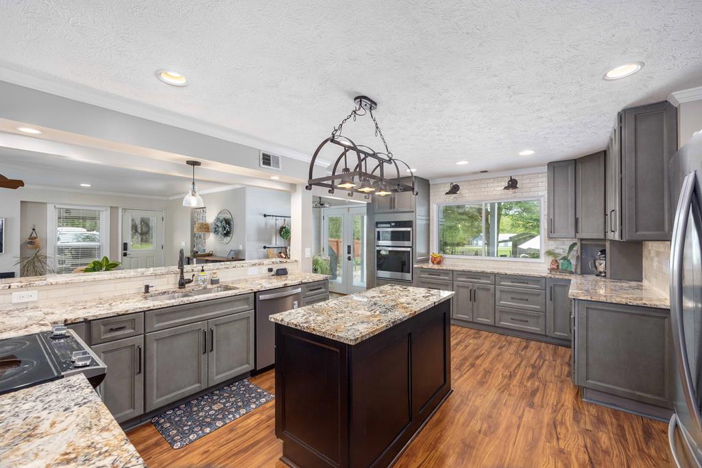 520 Terry Lane Fortson, GA 31808 - Photo 5 of 52 a kitchen with stainless steel appliances granite countertop a sink stove and refrigerator