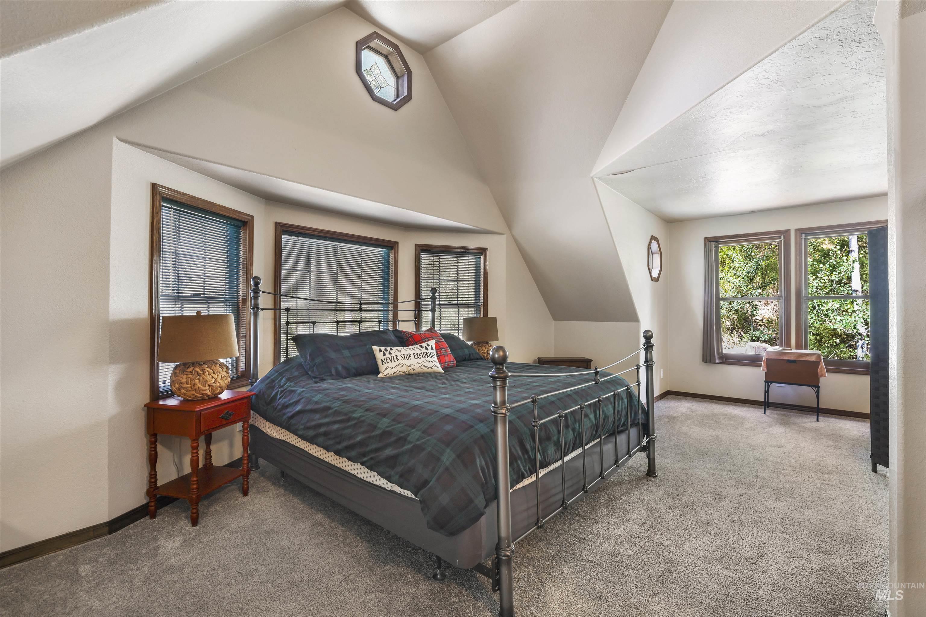 224 Dakota Road Mountain Home, ID 83647 - Photo 26 of 50 Carpeted room featuring sloped ceilings and multiple window exposures