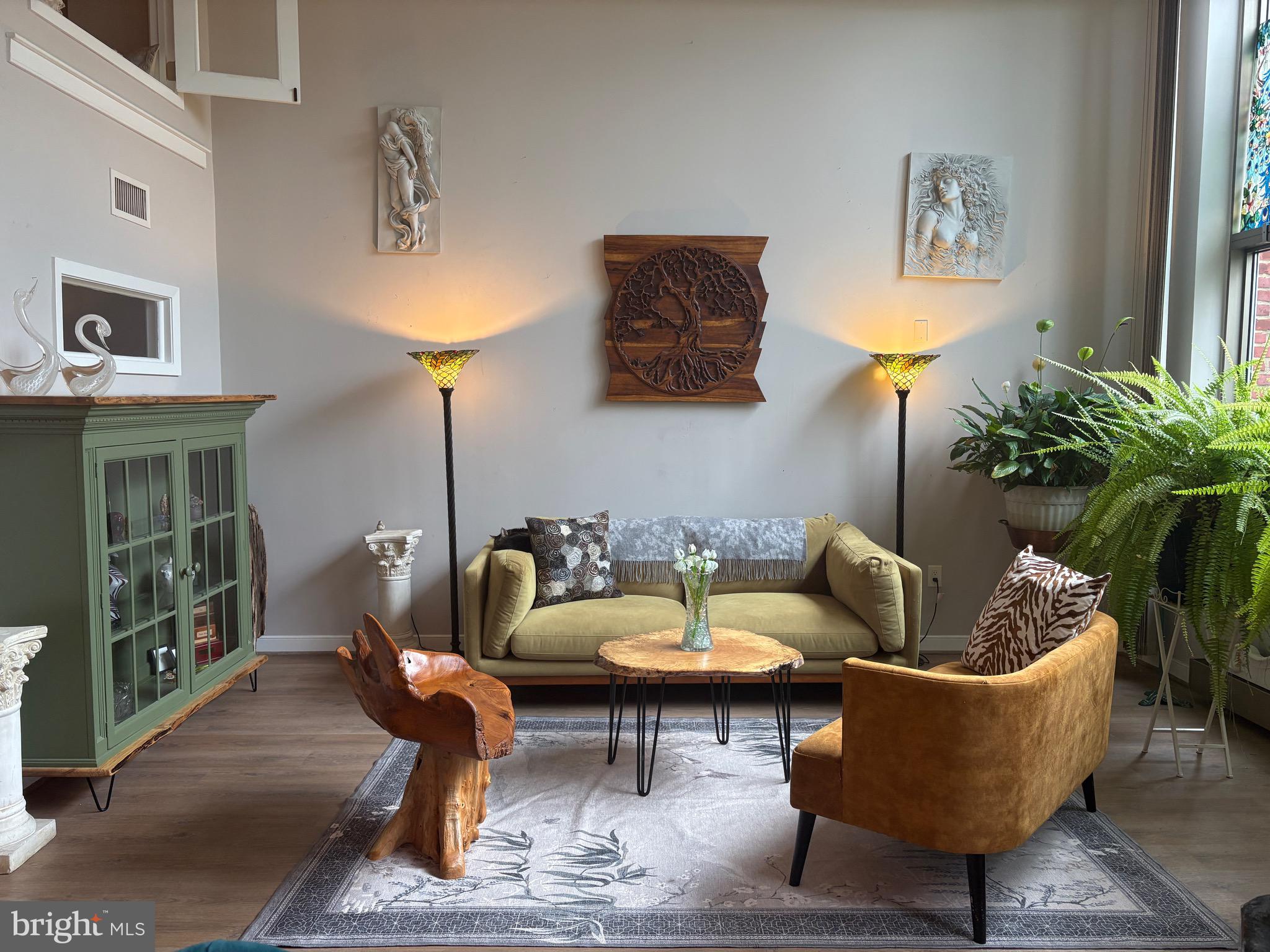 2901 Boston Street, Unit 206 Baltimore, MD 21224 - Photo 1 of 65 a living room with furniture and a potted plant