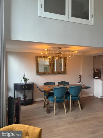 a kitchen with stainless steel appliances granite countertop a sink a stove and a wooden floors