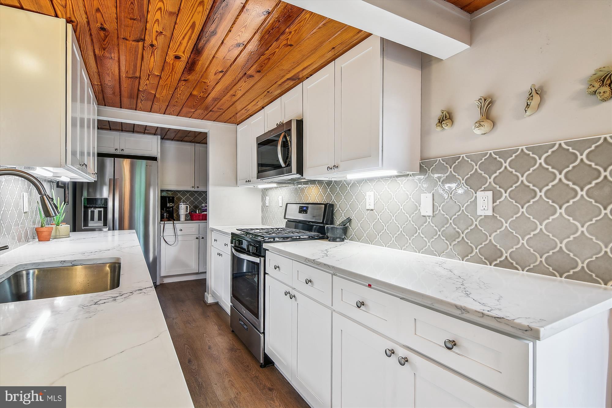 2901 Boston Street, Unit 206 Baltimore, MD 21224 - Photo 14 of 65 a kitchen with stainless steel appliances granite countertop a sink a stove and cabinets