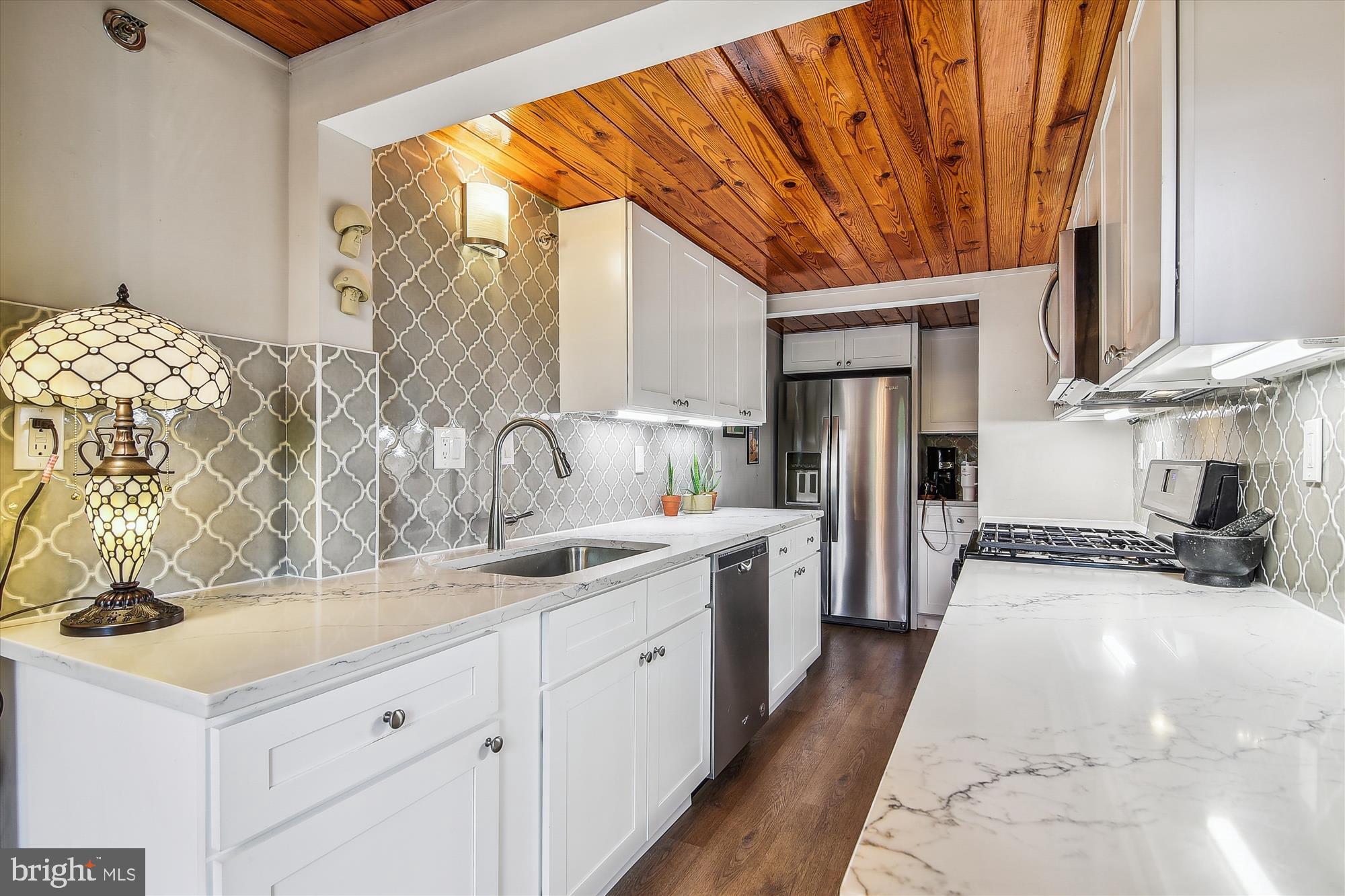 2901 Boston Street, Unit 206 Baltimore, MD 21224 - Photo 15 of 65 a kitchen with stainless steel appliances a sink stove and cabinets