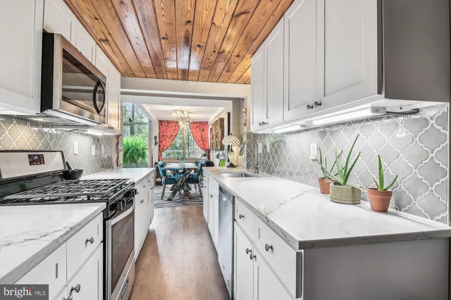 a large bedroom with a bed and wooden floor