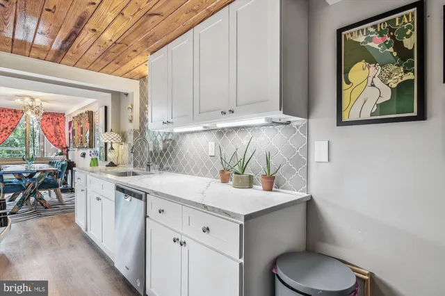 a bedroom with a bed mirror and window