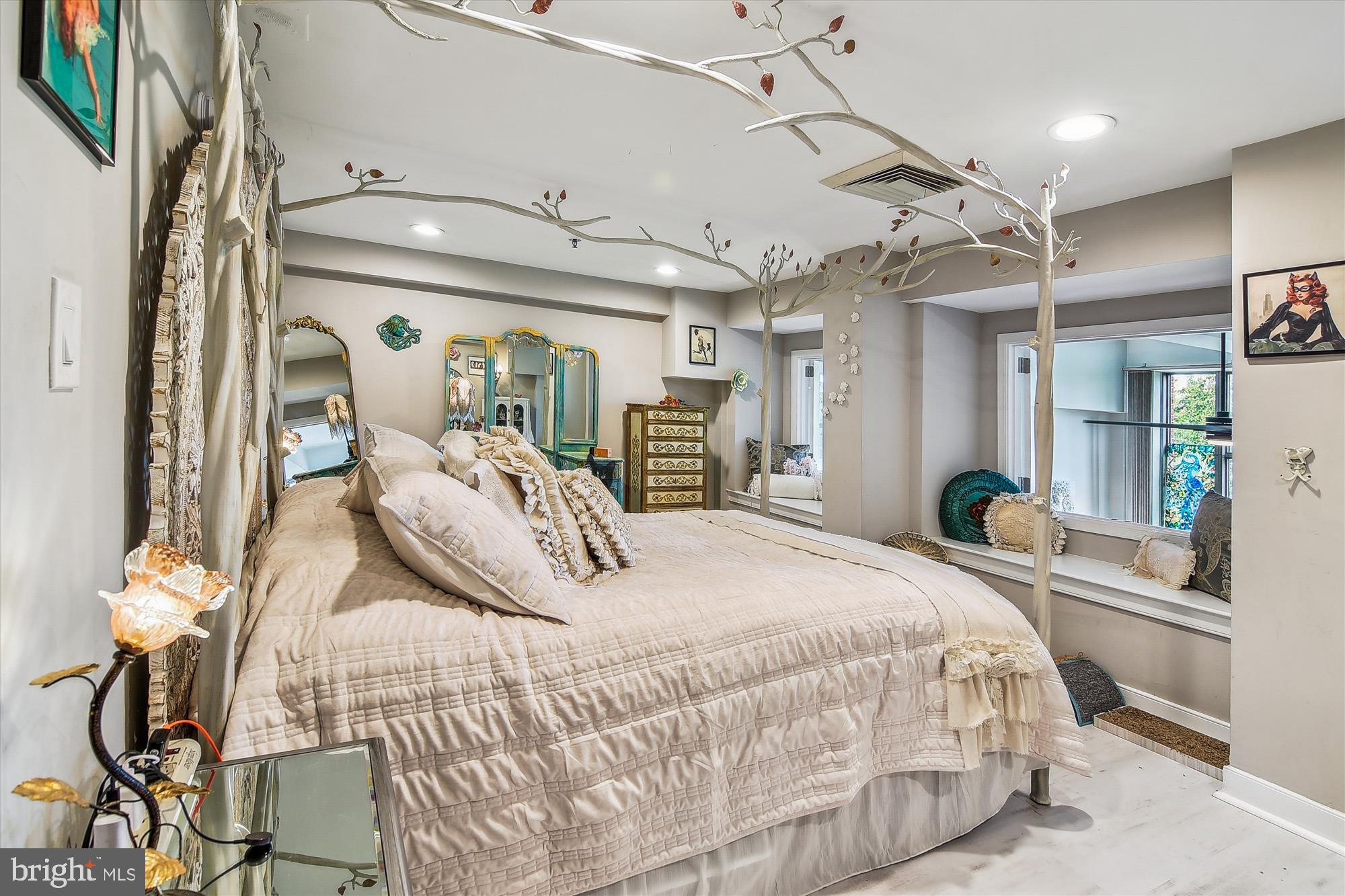 2901 Boston Street, Unit 206 Baltimore, MD 21224 - Photo 20 of 65 a large bedroom with a bed and wooden floor