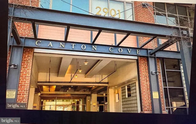 a view of a workspace with furniture and window