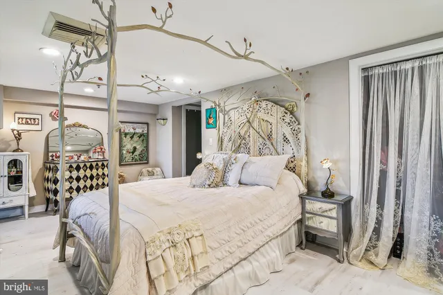 a large bed with a large mirror next to a window