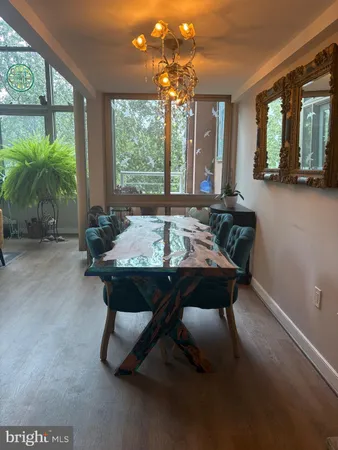 a view of a dining room with furniture large windows and wooden floor