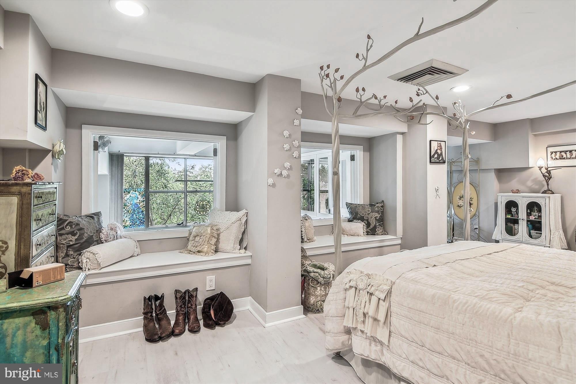 2901 Boston Street, Unit 206 Baltimore, MD 21224 - Photo 24 of 65 a bedroom with a bed a large window and furniture