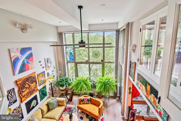 a living room with furniture and a potted plant