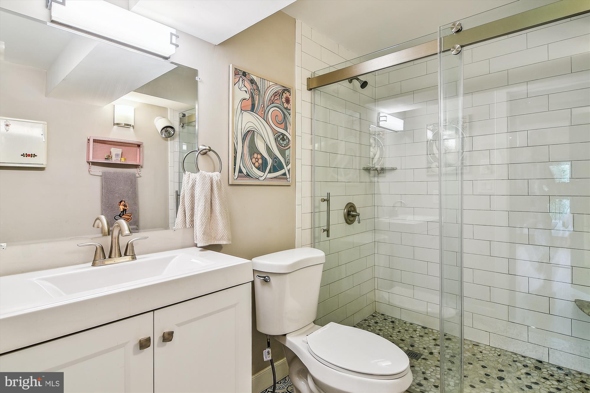 2901 Boston Street, Unit 206 Baltimore, MD 21224 - Photo 32 of 65 a bathroom with a sink toilet and shower
