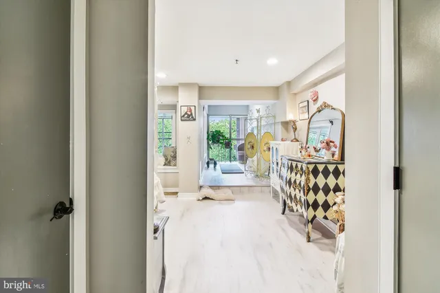 a view of staircase with lots of frames on wall and a dining table
