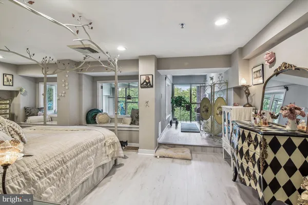 a large bed with a large mirror next to a window