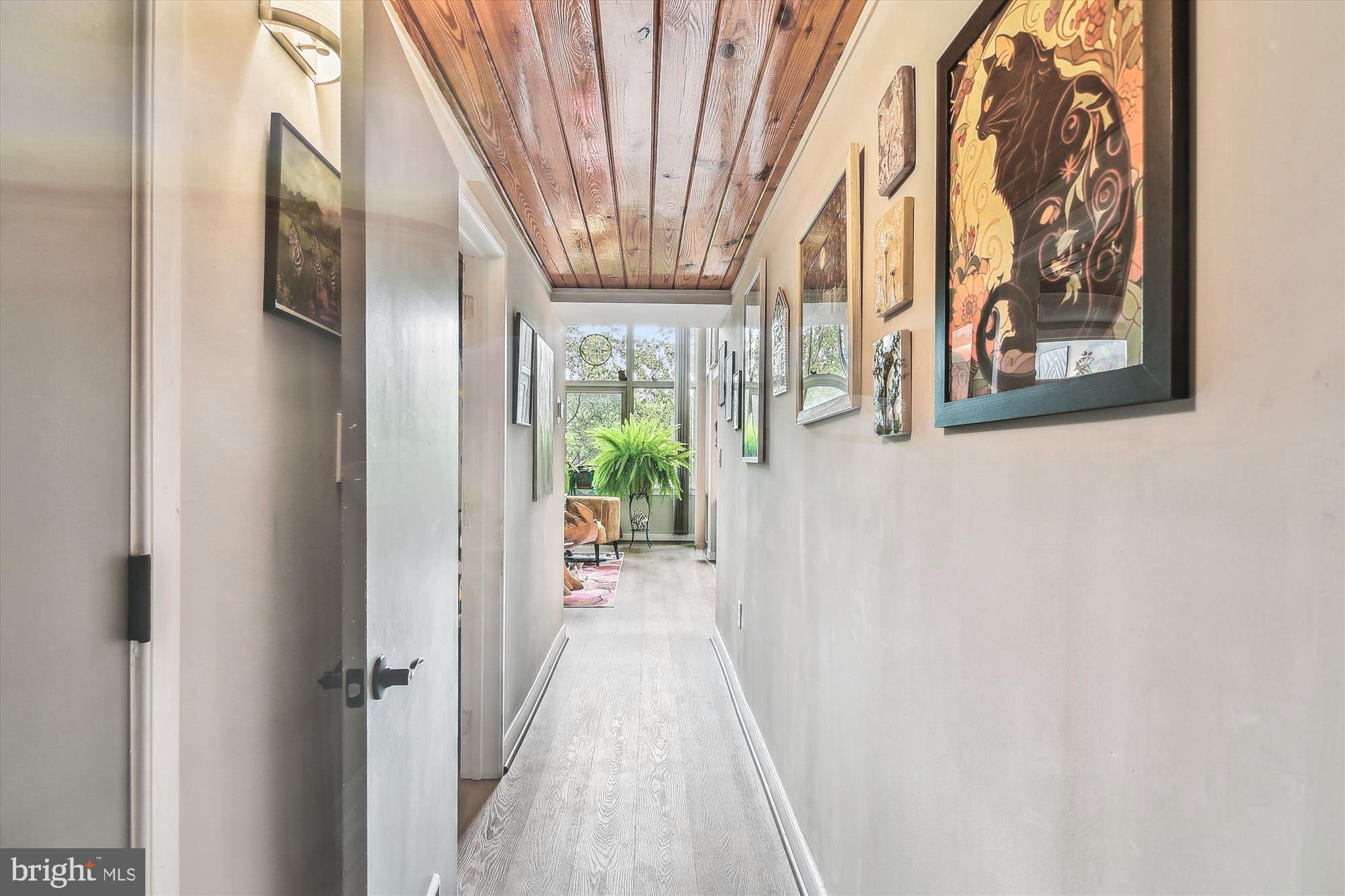 2901 Boston Street, Unit 206 Baltimore, MD 21224 - Photo 41 of 65 a view of a hallway with paintings on the wall