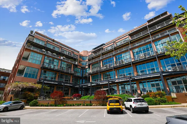 a view of a city street with parked cars