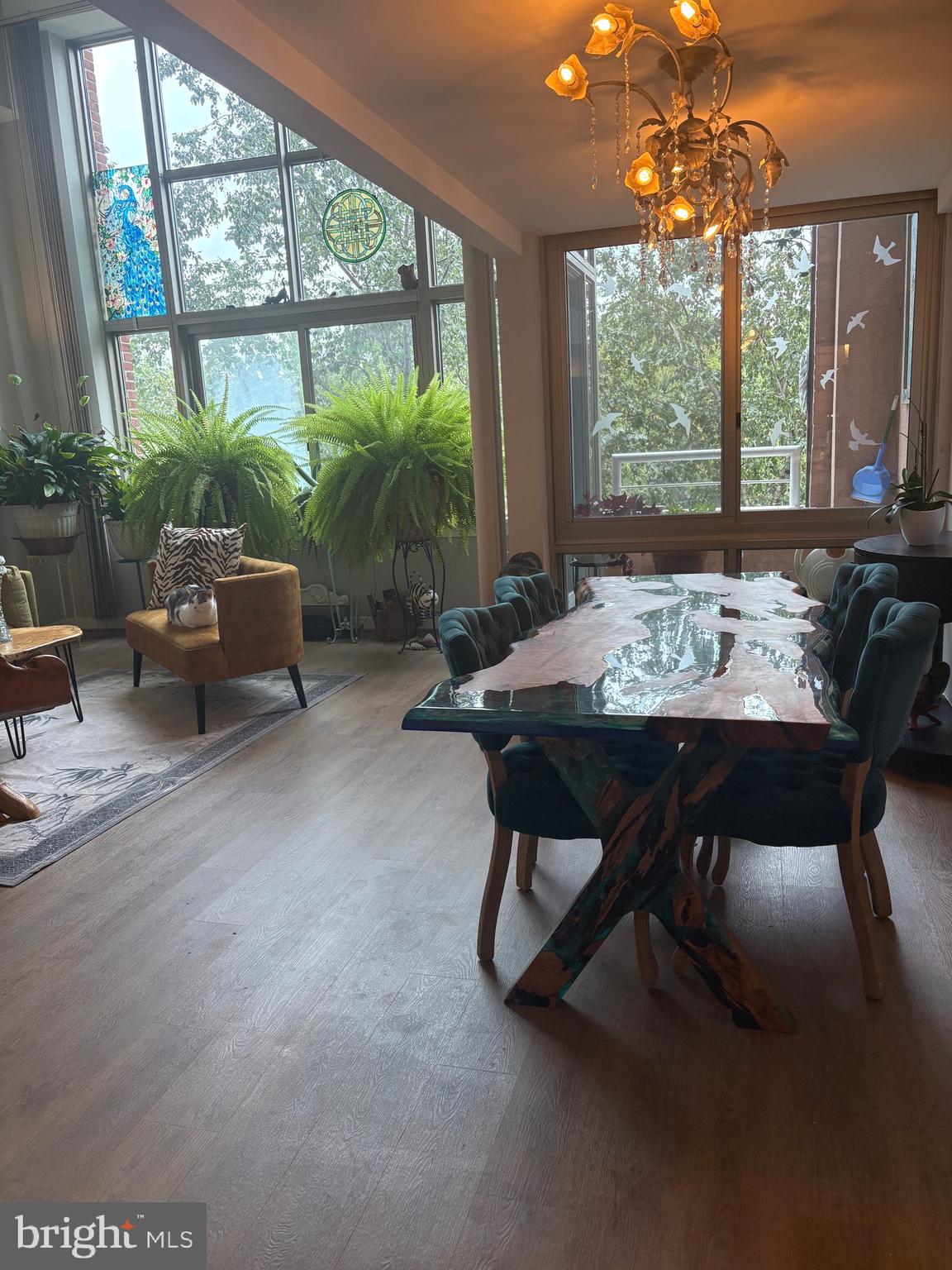 2901 Boston Street, Unit 206 Baltimore, MD 21224 - Photo 7 of 65 a view of a dining room with furniture large windows and wooden floor