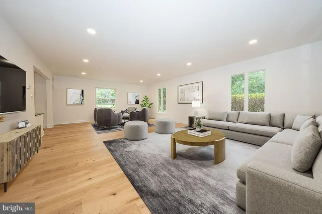 a living room with furniture window and flat screen tv