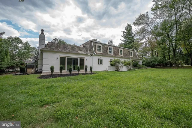 a front view of a house with a yard porch and garden