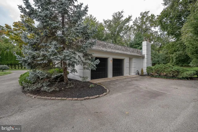 a view of a house with a tree and plants