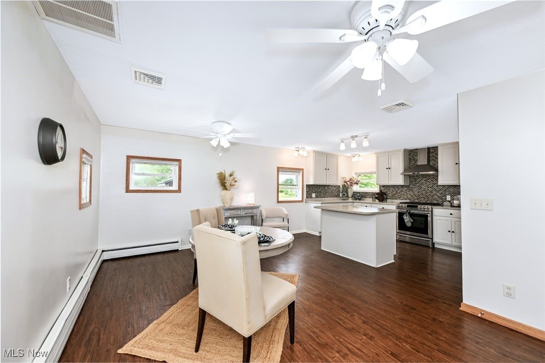 4597 Rock Cut Road Barberton, OH 44203 - Photo 13 of 44 *DINING AREA EAT IN KITCHEN IS LARGE ENOUGH FOR A 6-8 SEATER TABLE WITH DUAL FANS, LIGHTING AND LUXURY PLANK FLOORING - NEAR BREAKFAST BAR/ISLAND